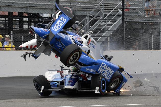 The car driven by Scott Dixon, of New Zealand, goes over the top of Jay Howard, of England, in the first turn during the running of the Indianapolis 500 auto race at Indianapolis Motor Speedway, Sunday, May 28, 2017, in Indianapolis. (AP Photo/Marty Seppala)