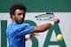 France's Maxime Hamou returns the ball to Uruguay's Pablo Cuevas during their tennis match at the Roland Garros 2017 French Open on May 29, 2017 in Paris. / AFP PHOTO / Eric FEFERBERG (Photo credit should read ERIC FEFERBERG/AFP/Getty Images)