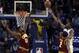 Golden State Warriors' Kevin Durant, right, lays up a shot against Cleveland Cavaliers' Tristan Thompson, left, and Kyrie Irving (2) during the first half of an NBA basketball game Monday, Jan. 16, 2017, in Oakland, Calif. (AP Photo/Ben Margot)