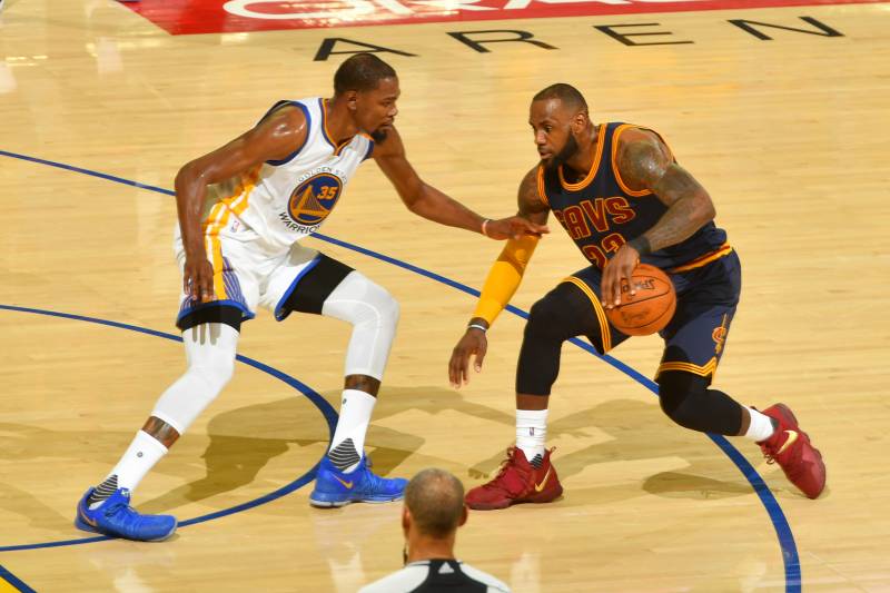 OAKLAND, CA - JUNE 1:  LeBron James #23 of the Cleveland Cavaliers handles the ball against Kevin Durant #35 of the Golden State Warriors in Game One of the 2017 NBA Finals on June 1, 2017 at ORACLE Arena in Oakland, California. NOTE TO USER: User expressly acknowledges and agrees that, by downloading and/or using this photograph, user is consenting to the terms and conditions of Getty Images License Agreement. Mandatory Copyright Notice: Copyright 2017 NBAE (Photo by Jesse D. Garrabrant/NBAE via Getty Images)