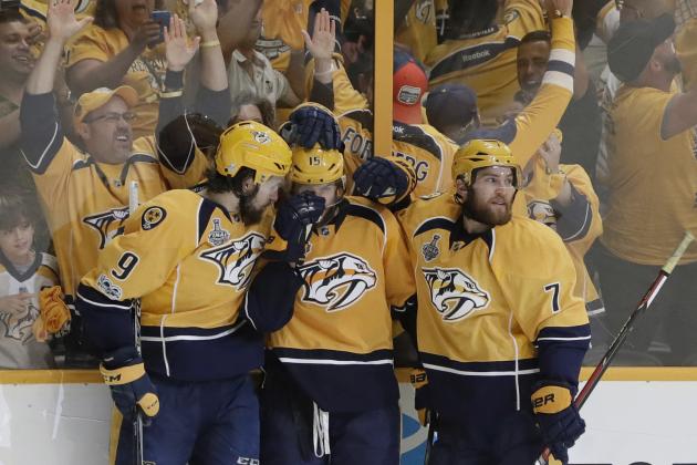 Nashville Predators left wing Filip Forsberg (9), of Sweden, and defenseman Yannick Weber (7), of Switzerland, celebrate with right wing Craig Smith (15) after Smith's goal against the Pittsburgh Penguins during the third period in Game 3 of the NHL hockey Stanley Cup Finals Saturday, June 3, 2017, in Nashville, Tenn. (AP Photo/Mark Humphrey)