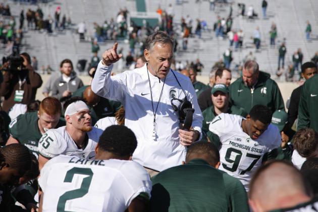 Michigan State coach Mark Dantonio, center, talks to his players following a spring NCAA college football scrimmage, Saturday, April 1, 2017, in East Lansing, Mich. The defense won 33-23. (AP Photo/Al Goldis)