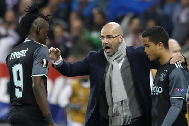 Ajax's coach Peter Bosz, center, gives directions to Ajax's Bertrand Traore, as substitute Justin Kluivert waits to enter the pitch during the second leg semi final soccer match between Olympique Lyon and Ajax in the Stade de Lyon, Decines, France, Thursday, May 11, 2017. (AP Photo/Laurent Cipriani)