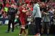 Liverpool player Steven Gerrard (2nd L) shakes hands with coach Jurgen Klopp after being substituted during their end-of-season friendly football match against Sydney FC at the Olympic Stadium in Sydney on May 24, 2017. / AFP PHOTO / WILLIAM WEST (Photo credit should read WILLIAM WEST/AFP/Getty Images)