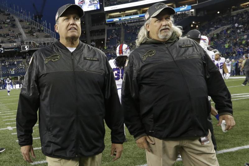 Buffalo Bills head coach Rex Ryan, left, stands with his twin brother, Rob Ryan, right, assistant head coach - defence, during warmups before an NFL football game against the Seattle Seahawks, Monday, Nov. 7, 2016, in Seattle. (AP Photo/Elaine Thompson)