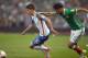 US player Christian Pulisic (L) is marked by Mexico's Diego Reyes during their 2018 FIFA World Cup Concacaf qualifier football match, in Mexico City, on June 11, 2017. / AFP PHOTO / Alfredo ESTRELLA (Photo credit should read ALFREDO ESTRELLA/AFP/Getty Images)