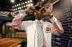 Hunter Greene, a pitcher and shortstop from Notre Dame High School in Sherman Oaks, Calif., walks off the stage after being selected No. 2 by the Cincinnati Reds in the first round of the Major League Baseball draft, Monday, June 12, 2017, in Secaucus, N.J. (AP Photo/Julio Cortez)