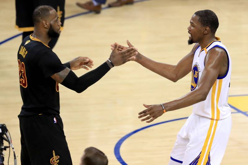 OAKLAND, CA - JUNE 12: Kevin Durant #35 of the Golden State Warriors shakes hands with LeBron James #23 of the Cleveland Cavaliers after defeating the Cleveland Cavaliers 129-120 in Game 5 to win the 2017 NBA Finals at ORACLE Arena on June 12, 2017 in Oakland, California. NOTE TO USER: User expressly acknowledges and agrees that, by downloading and or using this photograph, User is consenting to the terms and conditions of the Getty Images License Agreement. (Photo by Ronald Martinez/Getty Images)