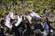 Golden State Warriors players, coaches and owners hold up the Larry O'Brien NBA Championship Trophy after Game 5 of basketball's NBA Finals between the Warriors and the Cleveland Cavaliers in Oakland, Calif., Monday, June 12, 2017. The Warriors won 129-120 to win the NBA championship. (AP Photo/Marcio Jose Sanchez)