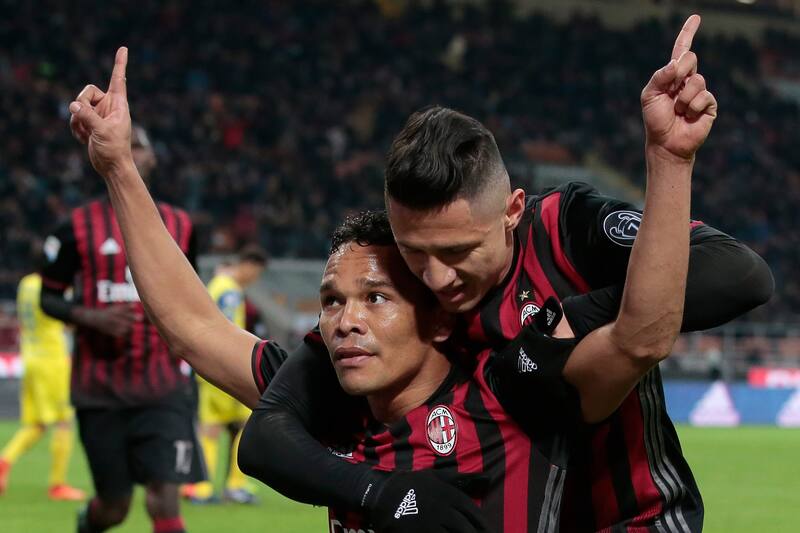 MILAN, ITALY - MARCH 04: Carlos Bacca of AC Milan (L) celebrates his second goal with his team-mate Gianluca Lapadula during the Serie A match between AC Milan and AC ChievoVerona at Stadio Giuseppe Meazza on March 4, 2017 in Milan, Italy. (Photo by Emilio Andreoli/Getty Images)