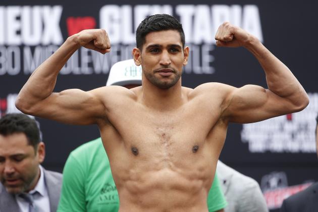 Amir Khan poses on the scale during a weigh-in Friday, May 6, 2016, in Las Vegas. Khan is scheduled to fight Canelo Alvarez in a middleweight championship bout Saturday in Las Vegas. (AP Photo/John Locher)