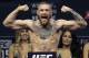 FILE - In this Nov. 11, 2016, file photo, Conor McGregor stands on a scale during the weigh-in event for his fight against Eddie Alvarez in UFC 205 mixed martial arts at Madison Square Garden in New York. Floyd Mayweather Jr. says facing UFC star McGregor in a boxing ring