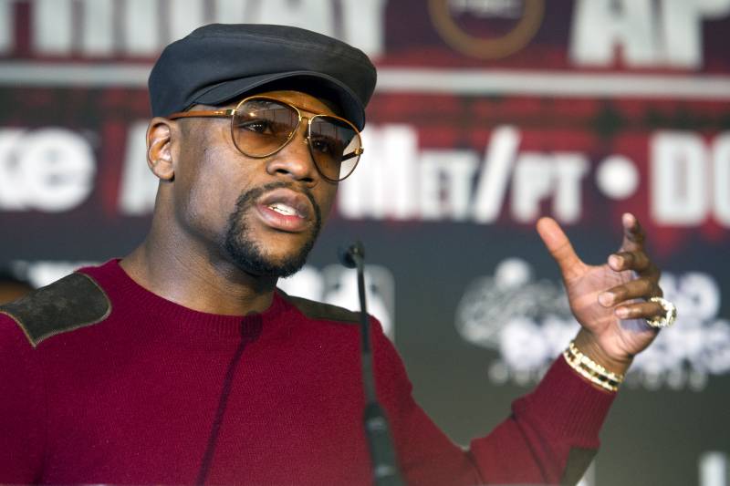 Five-division world champion Floyd Mayweather talks in Washington, Feb. 29, 2016, about the upcoming world title fight between four-division world champion Adrien