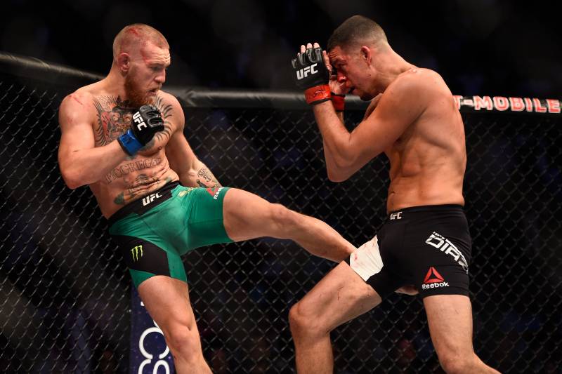 LAS VEGAS, NV - AUGUST 20: (L-R) Conor McGregor of Ireland kicks Nate Diaz in their welterweight bout during the UFC 202 event at T-Mobile Arena on August 20, 2016 in Las Vegas, Nevada. (Photo by Jeff Bottari/Zuffa LLC/Zuffa LLC via Getty Images)