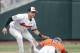 Oregon State second baseman Nick Madrigal, left, tags out Cal State Fullerton's Dillon Persinger (19) who was caught stealing second base in the third inning of an NCAA mens College World Series baseball game in Omaha, Neb., Saturday, June 17, 2017. (AP Photo/Nati Harnik)
