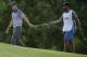 Jordan Spieth is handed a putter on the 15th hole during the second round of the U.S. Open golf tournament Friday, June 16, 2017, at Erin Hills in Erin, Wis. (AP Photo/Charlie Riedel)