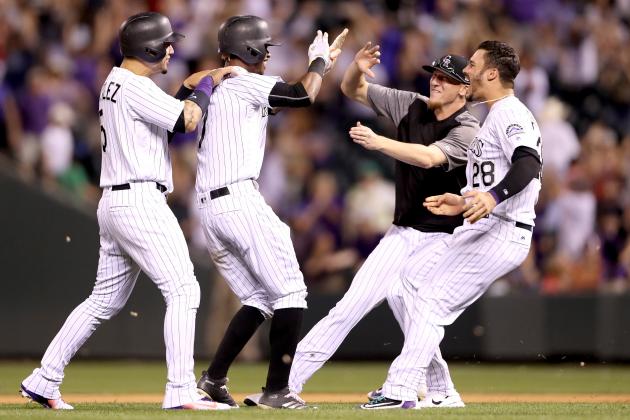 DENVER, CO - JUNE 15:  Raimel Tapia #7 of the Coloarado Rockies is congratulated by Carlos Gonzalez #5, Jeff Hoffman #34 and Nolan Arenado #12 after batting in the winning run in the bottom of the ninth inning against the San Francisco Giants at Coors Field on June 15, 2017 in Denver, Colorado.  (Photo by Matthew Stockman/Getty Images)