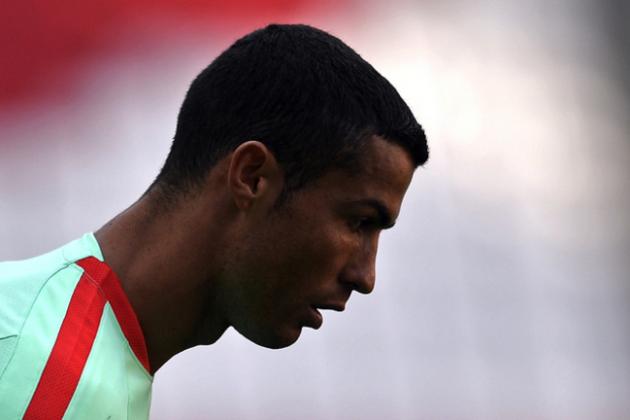 Portugal's Cristiano Ronaldo looks down in the shadow during a training session at the Arena in Kazan, Russia, on Saturday, June 17, 2017. Portugal will play Mexico in a Confederations Cup, Group A soccer match scheduled for Sunday, June 18, 2017. (AP Photo/Martin Meissner)