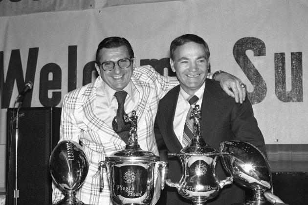 Two of the top winning percentage college coaches in the country, Penn State?s Joe Paterno, left, and Arizona State?s Frank Kush, pose for pictures, Saturday, Dec. 24, 1977 in Phoenix at a Fiesta Bowl luncheon. Paterno leads all coaches with a 820 percentage record while Kush is rated third with 772. The two coaches, both with Pennsylvania ties, will meet in the Fiesta Bowl in Tempe Arizona on December 25. (AP Photo/LM)