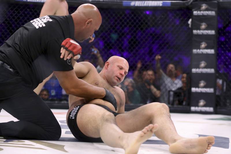 Fedor Emelianenko is tended to by the ref after being stopped by Matt Mitrione in a mixed martial arts bout at Bellator 180 on Saturday, June 24, 2017, in New York. Mitrione won via first-round stoppage. (AP Photo/Gregory Payan)