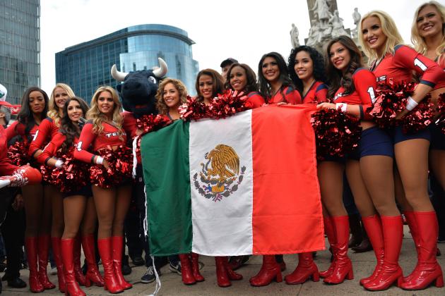 NFL Texans' cheerleaders pose with Mexico's national flag, in the roundabout of the Angel of the independence in Mexico City, on November 20, 2016. 
As the NFL returns to Mexico with a regular season game next Monday night, passion for the sport is soaring in this country where the round ball game of football is king. The National Football League estimates that it has 25 million fans in Mexico, a nation of 120 million people, making it the second most popular sport. / AFP / PEDRO PARDO        (Photo credit should read PEDRO PARDO/AFP/Getty Images)