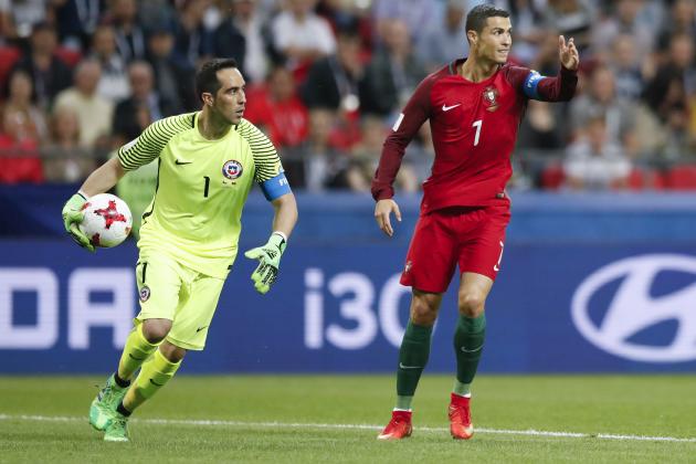 Portugal's Cristiano Ronaldo, right, gestures next to Chile goalkeeper Claudio Bravo during the Confederations Cup, semifinal soccer match between Portugal and Chile, at the Kazan Arena, Russia, Wednesday, June 28, 2017. (AP Photo/Pavel Golovkin)