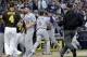 Los Angeles Dodgers manager Dave Roberts, center rear, is held back by third baseman Logan Forsythe (11) as the Dodgers and the San Diego Padres come onto the field during an argument in the second inning of a baseball game Friday, June 30, 2017, in San Diego. (AP Photo/Gregory Bull)