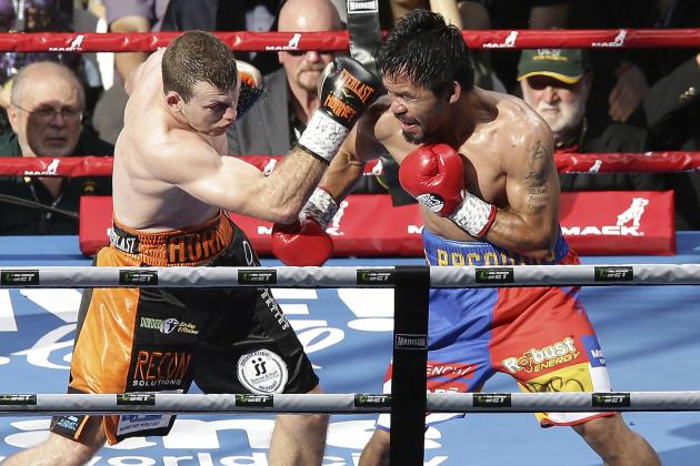 Jeff Horn, left, of Australia and Manny Pacquiao of the Philippines fight during their WBO World welterweight title bout in Brisbane, Australia, Sunday, July 2, 2017. Pacquiao lost his WBO welterweight world title to Horn in a stunning, unanimous points decision in the Sunday afternoon bout billed as the Battle of Brisbane in front of more than 50,000 people. (AP Photo/Tertius Pickard)