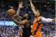 Houston Rockets guard James Harden, center, goes up for a shot between Oklahoma City Thunder center Steven Adams, rear, and forward Andre Roberson, right, in the first quarter of Game 4 of a first-round NBA basketball playoff series in Oklahoma City, Sunday, April 23, 2017. (AP Photo/Sue Ogrocki)