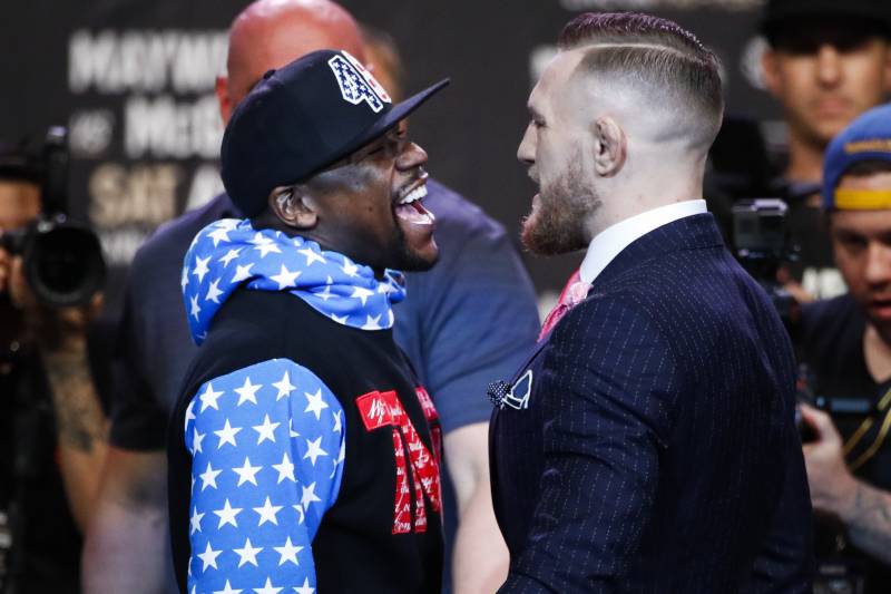 Floyd Mayweather Jr., left, and Conor McGregor exchange words during a news conference at Staples Center on Tuesday, July 11, 2017, in Los Angeles. The two will fight in a boxing match in Las Vegas on Aug. 26. (AP Photo/Jae C. Hong)