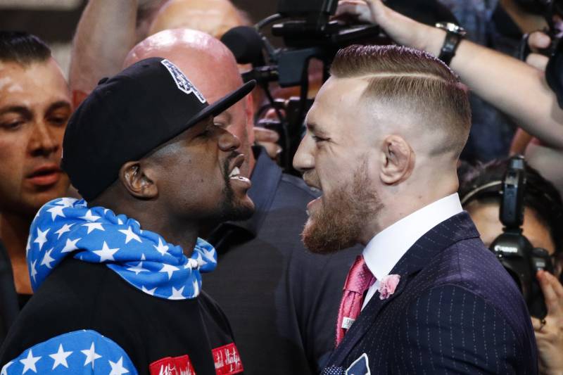 Floyd Mayweather Jr., left, and Conor McGregor exchange words during a news conference at Staples Center Tuesday, July 11, 2017, in Los Angeles. The two will fight in a boxing match in Las Vegas on Aug. 26. (AP Photo/Jae C. Hong)