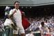 Switzerland's Roger Federer, left, celebrates as he leaves the court after beating Canada's Milos Raonic, right, at the end of their Men's Singles Quarterfinal Match on day nine at the Wimbledon Tennis Championships in London Wednesday, July 12, 2017. (AP Photo/Kirsty Wigglesworth)