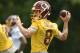 FILE - In this June 14, 2017, file photo, Washington Redskins quarterback Kirk Cousins (8) looks to pass during NFL football practice, in Ashburn, Va. With the deadline for a long-term deal with Kirk Cousins looming, Eric Schaffer, the team's