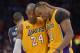 Los Angeles Lakers guard Kobe Bryant, left, hugs center Dwight Howard in the closing seconds of their NBA basketball game against the Memphis Grizzlies, Friday, April 5, 2013, in Los Angeles. The Lakers won 86-84. (AP Photo/Mark J. Terrill)