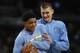 Denver Nuggets guard Gary Harris (14), front, jokes with Denver Nuggets center Nikola Jokic (15) in the second half of an NBA basketball game Saturday, March 12, 2016, in Denver. The Nuggets won 116-100. (AP Photo/David Zalubowski)