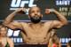 Demetrious Johnson poses on the scale during a weigh-in for UFC 197, Friday, April 22, 2016, in Las Vegas. Johnson is scheduled to fight Henry Cejudo in a flyweight title fight Saturday in Las Vegas. (AP Photo/John Locher)