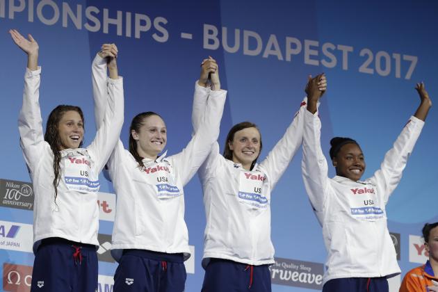 United States' Mallory Comerford, Kelsi Worrell, Katie Ledecky, and Simone Manuel, from left, attend the ceremony after winning the gold medal in the women's 4x100-meter freestyle final during the swimming competitions of the World Aquatics Championships in Budapest, Hungary, Sunday, July 23, 2017.(AP Photo/Michael Sohn)