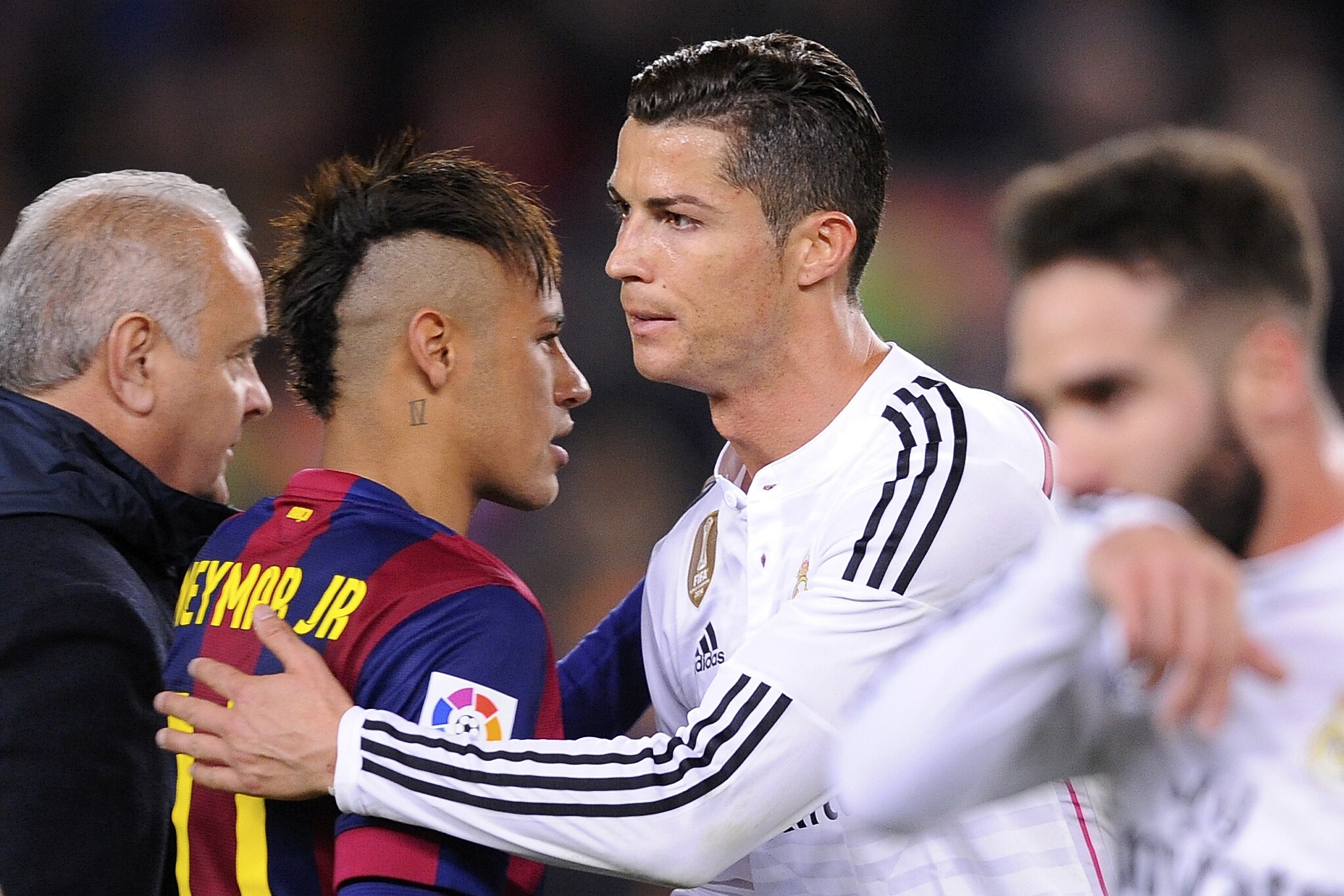 Real Madrid's Cristiano Ronaldo, centre right, pats Barcelona's Neymar on the back at the end of a Spanish La Liga soccer match between FC Barcelona and Real Madrid at Camp Nou stadium, in Barcelona, Spain, Sunday, March 22, 2015. (AP Photo/Manu Fernandez)
