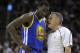 Golden State Warriors forward Draymond Green (23) talks with referee Monty McCutchen (13) against the Cleveland Cavaliers during the first half of Game 3 of basketball's NBA Finals in Cleveland, Wednesday, June 7, 2017. (AP Photo/Tony Dejak)