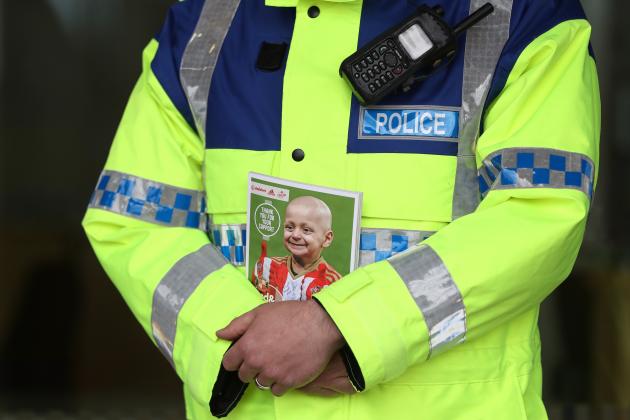 SUNDERLAND, ENGLAND - MAY 13: A police officer is seen holding the match day programme displaying a image of Bradley Lowery outside the stadium prior to the Premier League match between Sunderland and Swansea City at Stadium of Light on May 13, 2017 in Sunderland, England.  (Photo by Ian MacNicol/Getty Images)