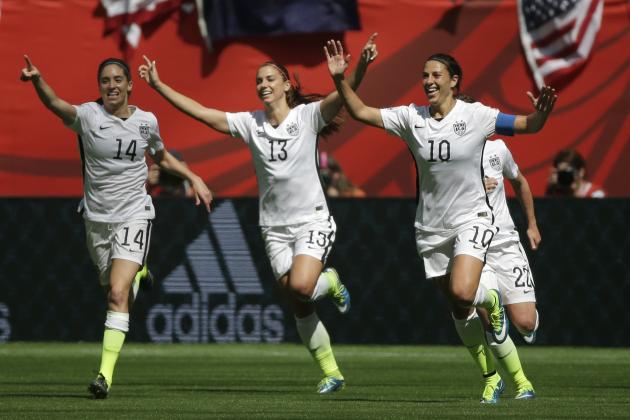 From left, United States' Morgan Brian, Alex Morgan, and Carli Lloyd celebrate after Lloyd scored her second goal of the match against Japan during the first half of the FIFA Women's World Cup soccer championship in Vancouver, British Columbia, Canada, Sunday, July 5, 2015. (AP Photo/Elaine Thompson)