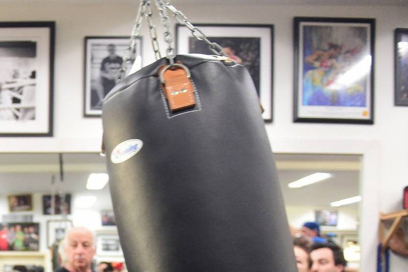 Two-time Chinese Olympic gold medalist boxer Zou Shiming hits a punching bag during a workout open to the media in Hollywood, California on February 17, 2015, where he and his coach Freddy Roach met with the press. Hall of Fame trainer Freddie Roach says China's Zou Shiming must forget everything he thinks he knows about Amnat Ruenroeng if he wants to seize the Thai's flyweight world title next month. AFP PHOTO/ FREDERIC J. BROWN (Photo credit should read FREDERIC J. BROWN/AFP/Getty Images)
