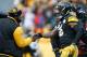 PITTSBURGH, PA - JANUARY 08: Le'Veon Bell #26 of the Pittsburgh Steelers celebrates with head coach Mike Tomlin after scoring a touchdown during the second quarter against the Miami Dolphins in the AFC Wild Card game at Heinz Field on January 8, 2017 in Pittsburgh, Pennsylvania. (Photo by Gregory Shamus/Getty Images)