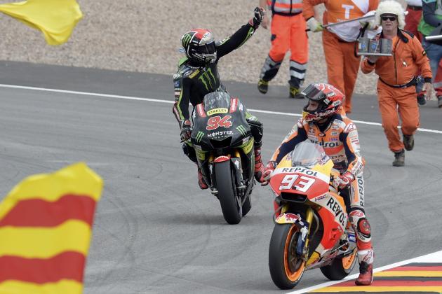Moto GP riders Jonas Folger of Germany, left, and Marc Marquez of Spain celebrate with race track marshalls after crossing the finish line of the German Motorcycle Grand Prix at the Sachsenring circuit in Hohenstein-Ernstthal, Germany, Sunday, July 2, 2017. Mrquez won the race and Folger was second. (AP Photo/Jens Meyer)