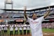 Former Philadelphia Phillies catcher Darren Daulton waves to the crowd as he takes the field during the Philadelphia Phillies Alumni ceremonies before a baseball game against the Atlanta Braves on Saturday, Aug. 3, 2013, in Philadelphia. (AP Photo/Michael Perez)