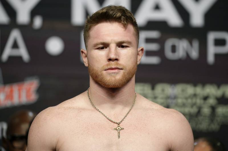 Canelo Alvarez stands on the scale during a weigh-in Friday, May 5, 2017, in Las Vegas. Alvarez is scheduled to fight Julio Cesar Chavez Jr. in a catch weight boxing match Saturday in Las Vegas. (AP Photo/John Locher)