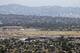 The site of construction of the new Los Angeles Rams and Chargers stadium, Los Angeles Stadium at Hollywood Park, with the Forum in the background in Inglewood, Calif., is seen in this aerial photo taken Thursday, May 25, 2017. (AP Photo/Reed Saxon)