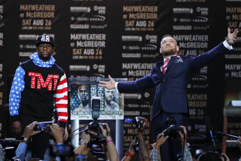Floyd Mayweather Jr., left, and Conor McGregor pause for photos during a news conference at Staples Center Tuesday, July 11, 2017, in Los Angeles. The two will fight in a boxing match in Las Vegas on Aug. 26. (AP Photo/Jae C. Hong)