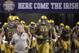 Notre Dame head coach Brian Kelly, left, runs on to the field with his players before an NCAA college football game against Army, Saturday, Nov. 12, 2016, in San Antonio. (AP Photo/Darren Abate)