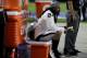 Oakland Raiders running back Marshawn Lynch (24) sits during the national anthem prior to an NFL preseason football game against the Arizona Cardinals, Saturday, Aug. 12, 2017, in Glendale, Ariz. (AP Photo/Rick Scuteri)